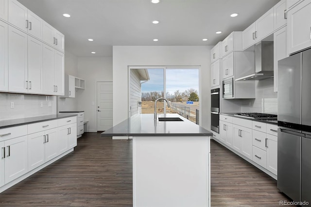 kitchen with a sink, backsplash, stainless steel appliances, wall chimney exhaust hood, and dark wood-style flooring