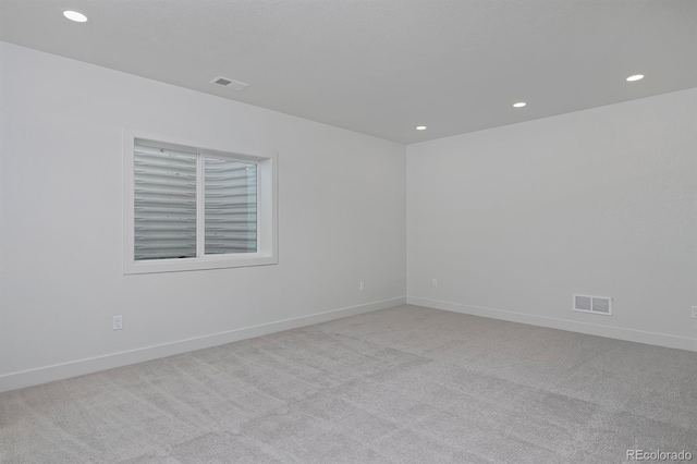 empty room with visible vents, baseboards, and carpet floors