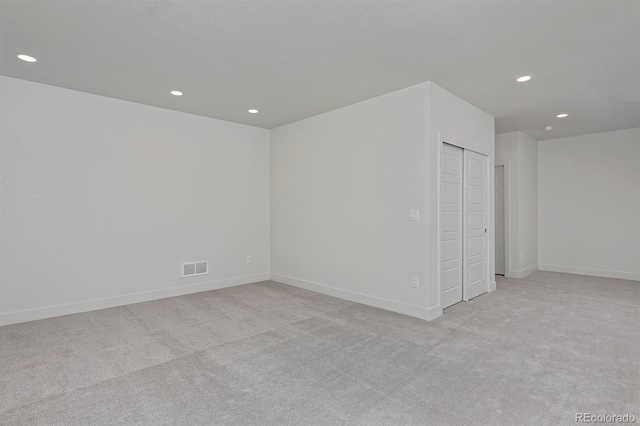 unfurnished bedroom with recessed lighting, visible vents, and light colored carpet