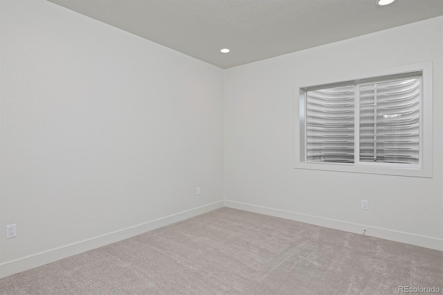 empty room with recessed lighting, baseboards, and carpet floors