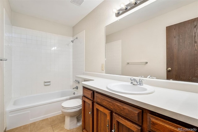 bathroom with toilet, tile patterned floors, vanity, and shower / washtub combination