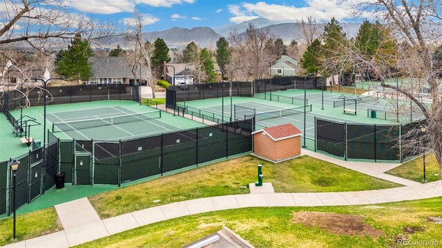 view of tennis court featuring a mountain view
