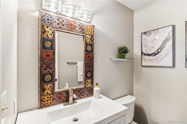 bathroom featuring vanity and toilet