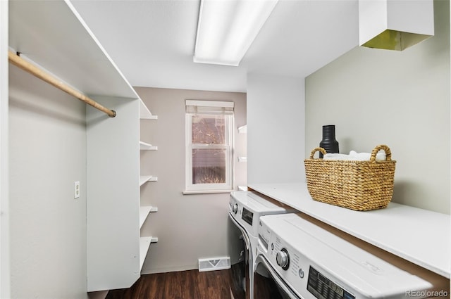 laundry room with dark wood-type flooring and washing machine and dryer