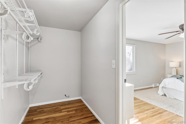 walk in closet with hardwood / wood-style flooring and ceiling fan