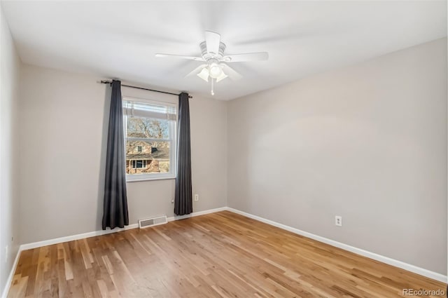 unfurnished room with ceiling fan and light wood-type flooring