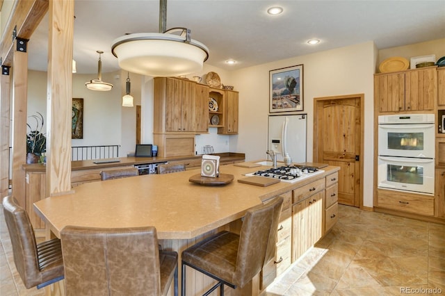 kitchen featuring white appliances, a kitchen island, a breakfast bar, decorative light fixtures, and open shelves