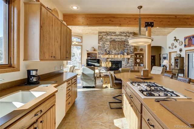 kitchen featuring arched walkways, beam ceiling, open floor plan, a stone fireplace, and white appliances