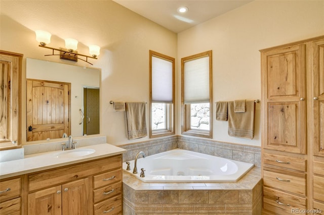 bathroom with a bath and vanity