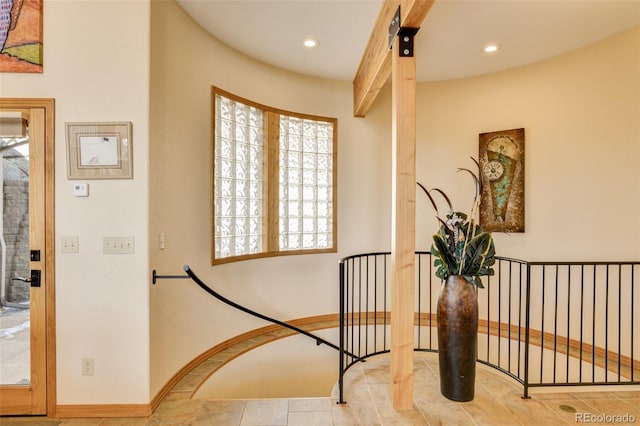 hall with baseboards, beamed ceiling, and recessed lighting