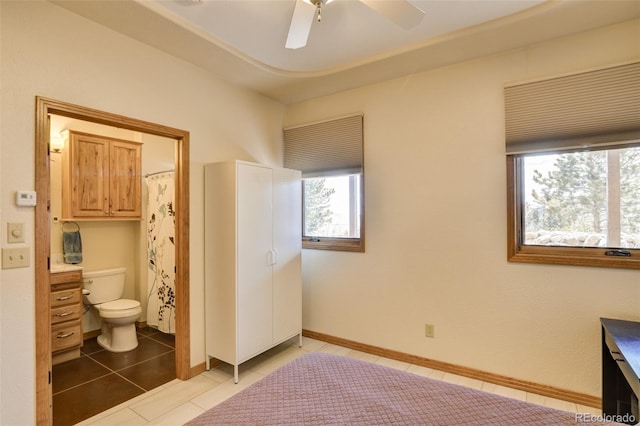 full bath featuring toilet, a ceiling fan, vanity, baseboards, and tile patterned floors