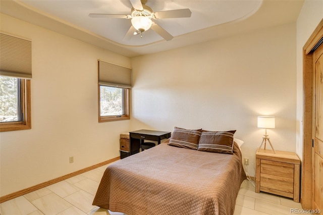 bedroom featuring baseboards and a ceiling fan