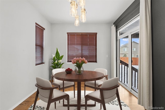 dining area featuring a chandelier and light hardwood / wood-style flooring