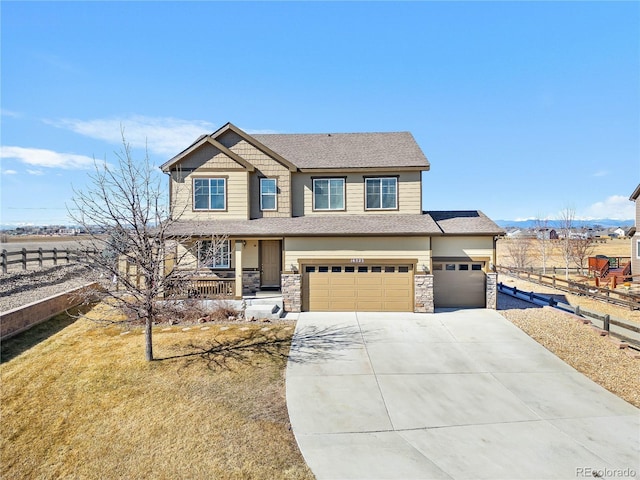 view of front of house featuring driveway, a garage, stone siding, covered porch, and fence