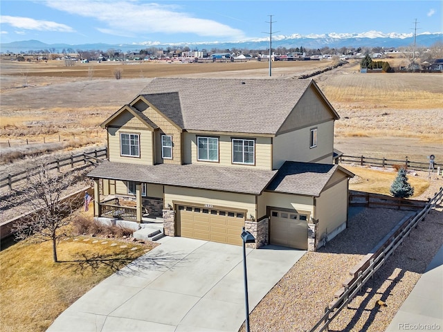 view of front of house with driveway, stone siding, an attached garage, fence, and a porch