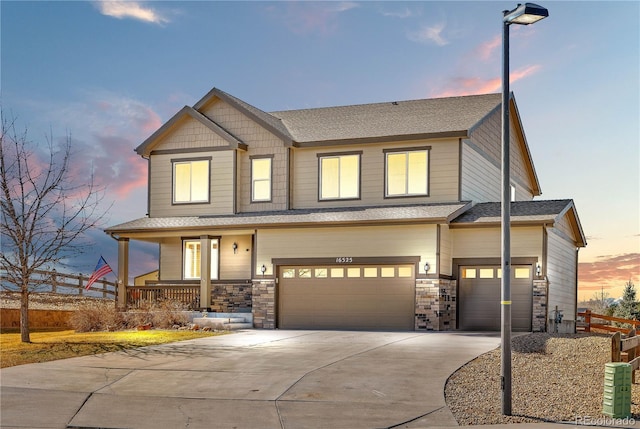 view of front of property featuring a porch, concrete driveway, fence, and an attached garage