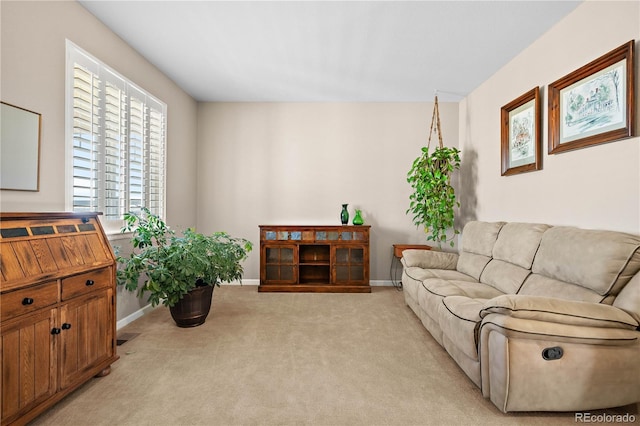 living room featuring light carpet and baseboards