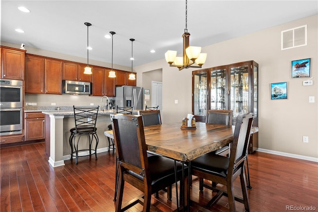 dining room with recessed lighting, visible vents, baseboards, dark wood finished floors, and an inviting chandelier