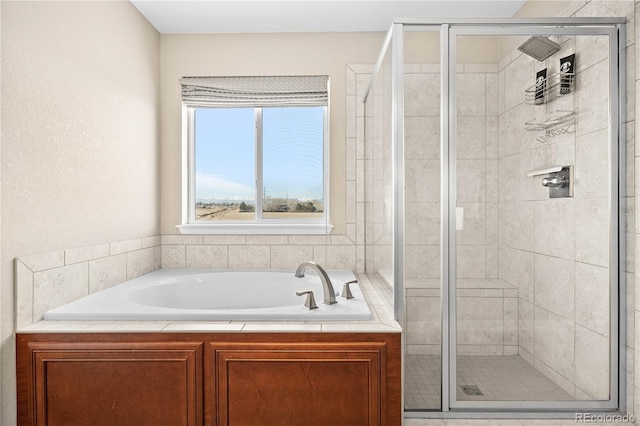 bathroom featuring a stall shower and a bath