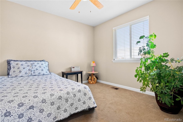 carpeted bedroom with ceiling fan, visible vents, and baseboards