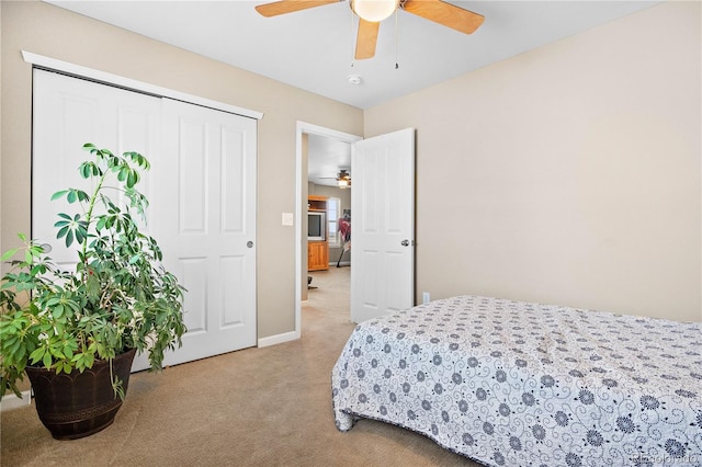 carpeted bedroom featuring ceiling fan and baseboards