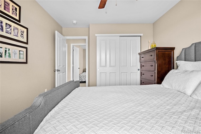 bedroom with ceiling fan and a closet