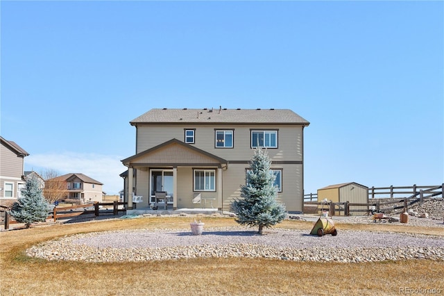 rear view of house featuring fence