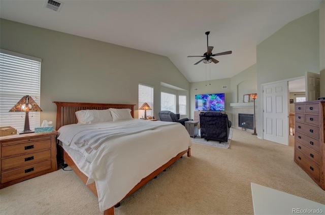 bedroom featuring ceiling fan, high vaulted ceiling, and light carpet