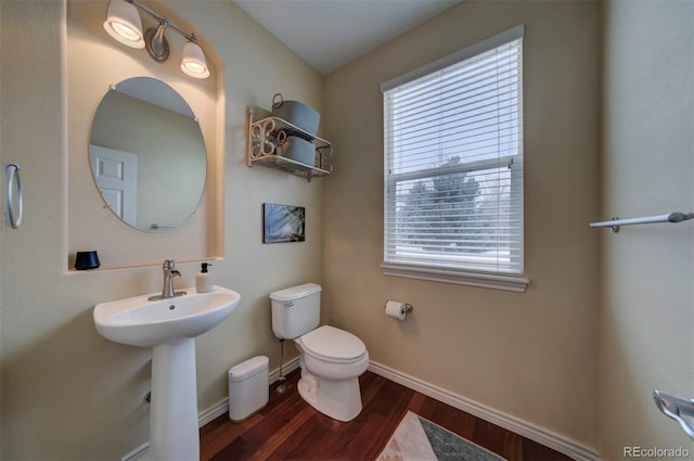 bathroom with sink, toilet, and hardwood / wood-style floors