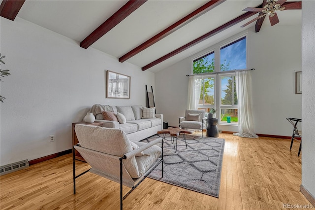 living area featuring beamed ceiling, ceiling fan, wood finished floors, high vaulted ceiling, and baseboards
