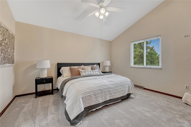 carpeted bedroom with baseboards, vaulted ceiling, and a ceiling fan