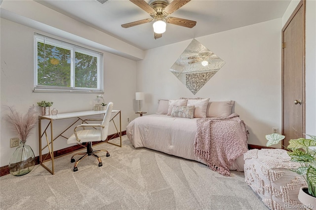 bedroom with carpet flooring, baseboards, an office area, and a ceiling fan