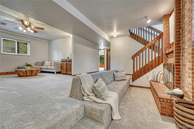 living room with carpet, baseboards, a ceiling fan, and healthy amount of natural light