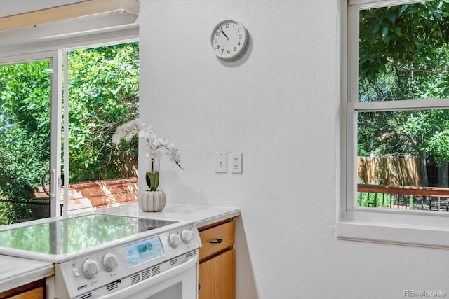 8705 W 86th Dr, Arvada, CO 80005 - kitchen with white electric stove, light countertops, and plenty of natural light