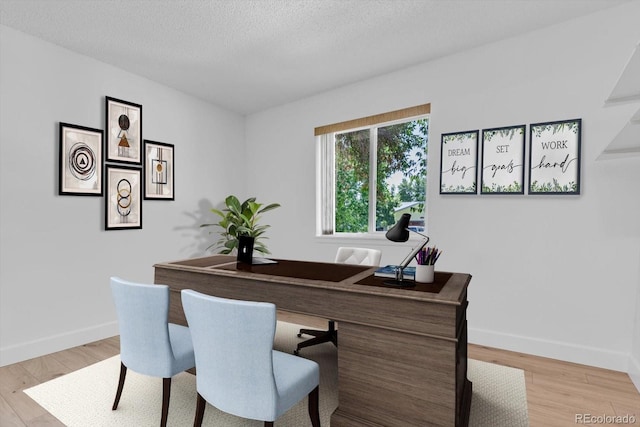 8705 W 86th Dr, Arvada, CO 80005 - office area with light wood-type flooring and a textured ceiling