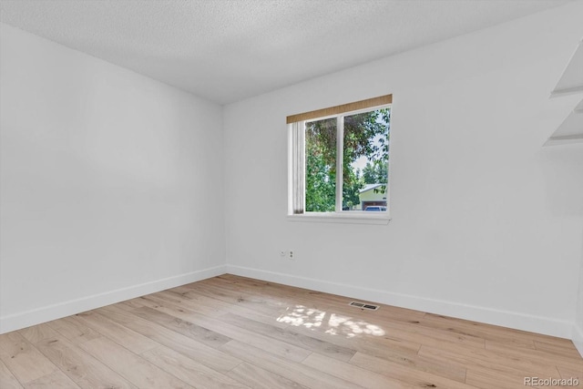 8705 W 86th Dr, Arvada, CO 80005 - spare room with wood finished floors and a textured ceiling