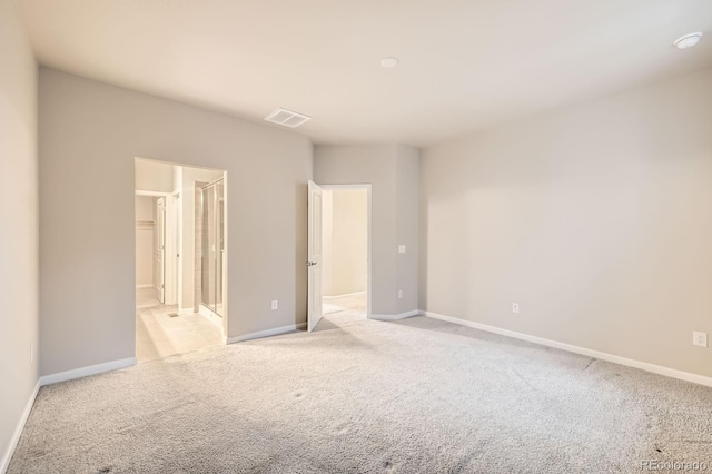 unfurnished bedroom featuring light carpet, visible vents, and baseboards