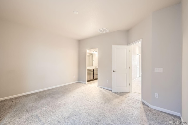 unfurnished bedroom with light colored carpet, visible vents, and baseboards