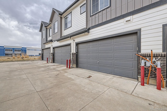 garage featuring concrete driveway