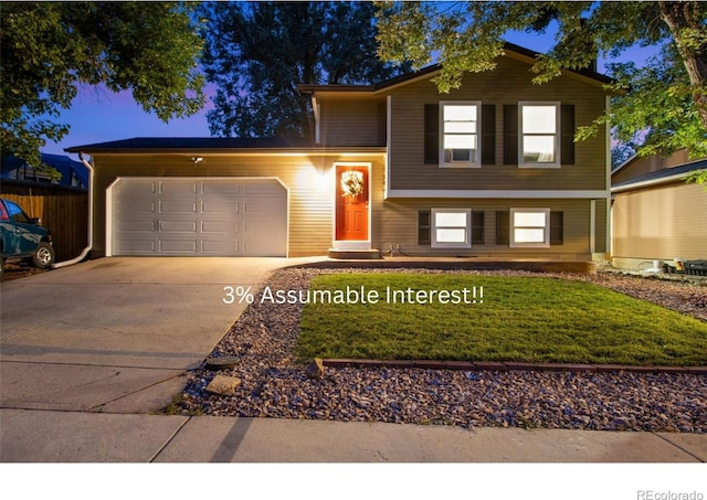 view of front of house with a garage and a front lawn