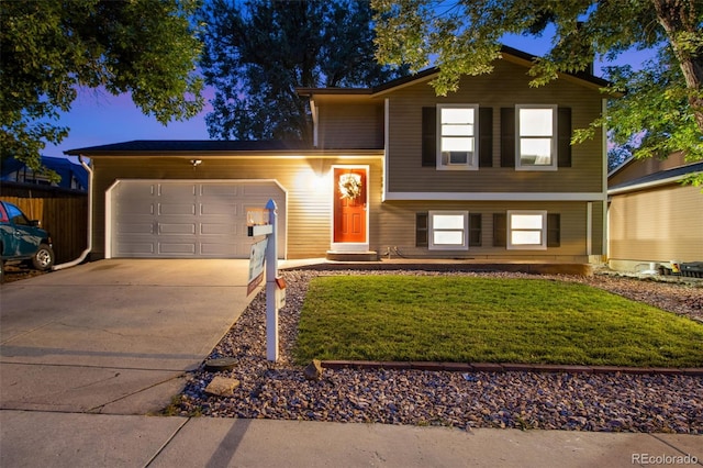 split level home featuring a front lawn and a garage