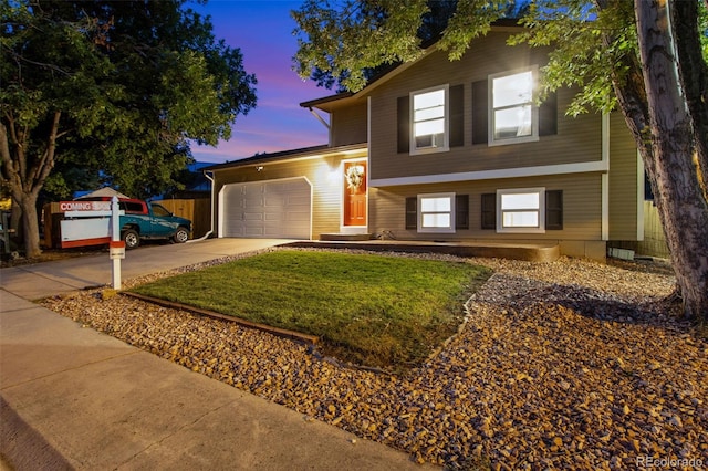 view of front of property featuring a lawn and a garage