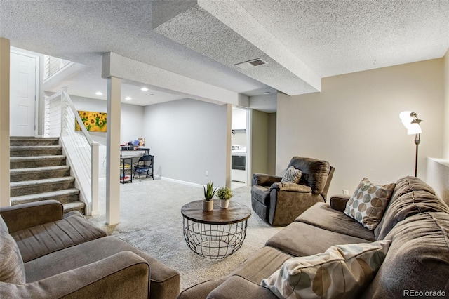 carpeted living room featuring a textured ceiling