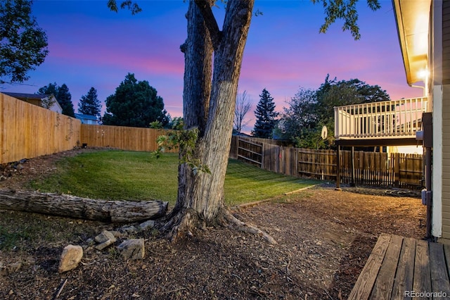 yard at dusk with a wooden deck