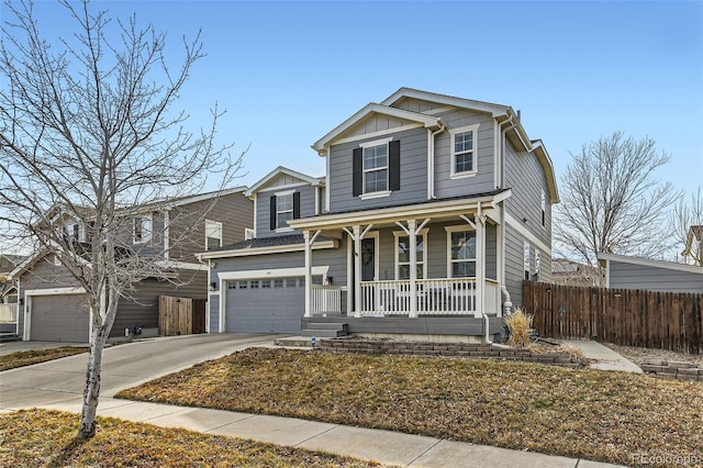 traditional-style home with a porch, board and batten siding, fence, a garage, and driveway