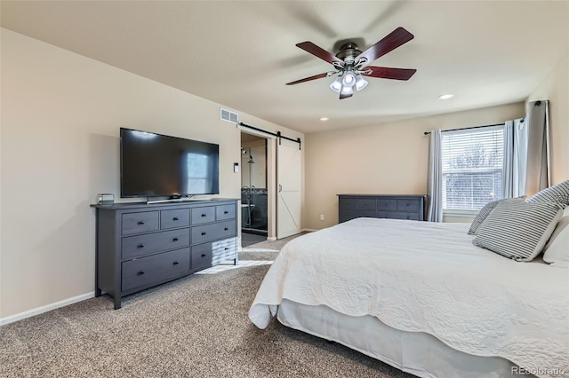 bedroom featuring a barn door, visible vents, baseboards, light colored carpet, and recessed lighting