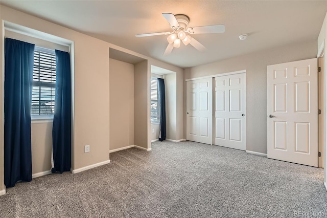 unfurnished bedroom with carpet, baseboards, and a closet