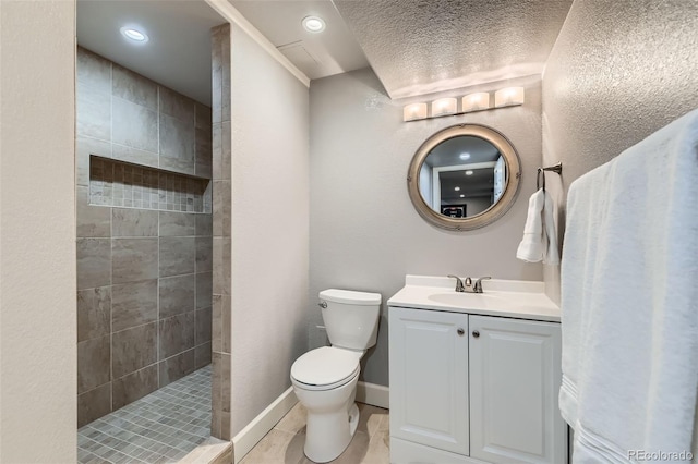 full bathroom with a textured wall, toilet, vanity, baseboards, and walk in shower