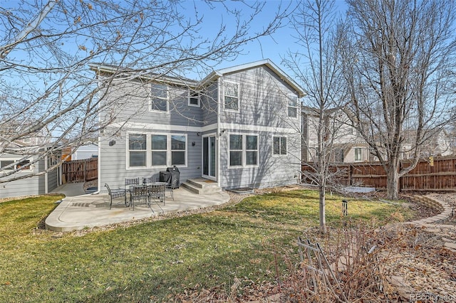 back of house with a yard, entry steps, a patio area, and fence