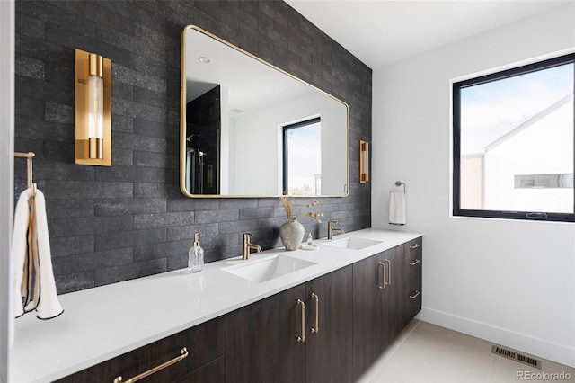 full bathroom with tile patterned floors, visible vents, backsplash, and a sink